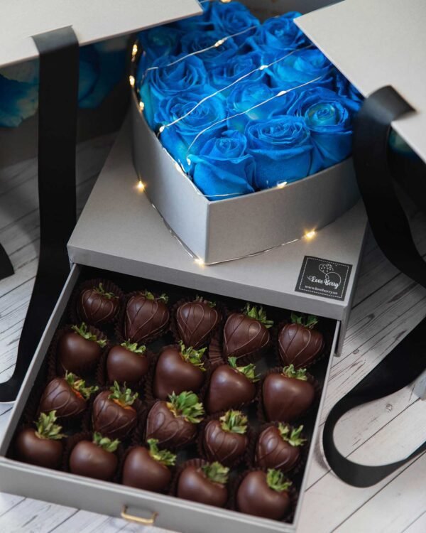 Blue roses and milk chocolate strawberries