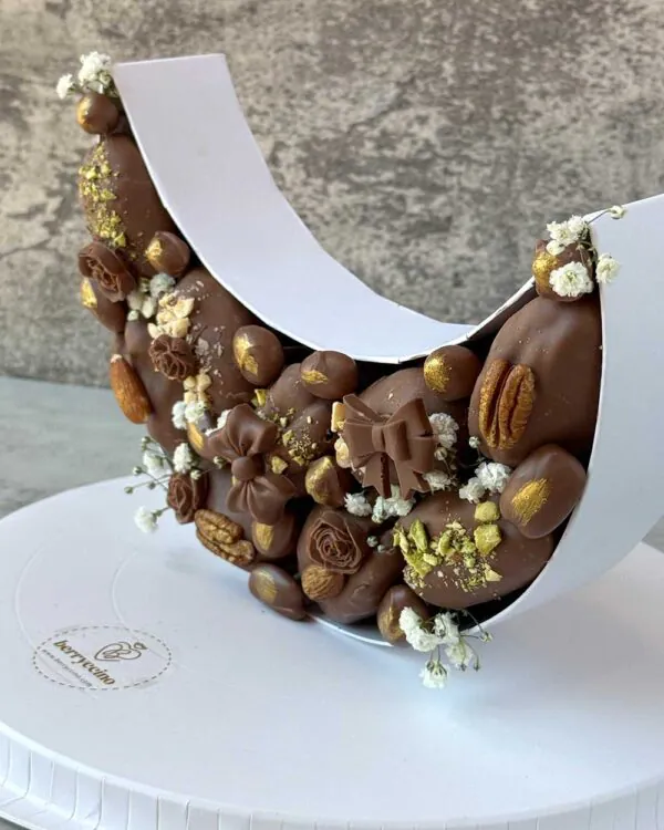 Iftar Delight – a crescent moon-shaped box with chocolate-covered dates and premium nuts, perfect for Ramadan Iftar and Eid gifting.