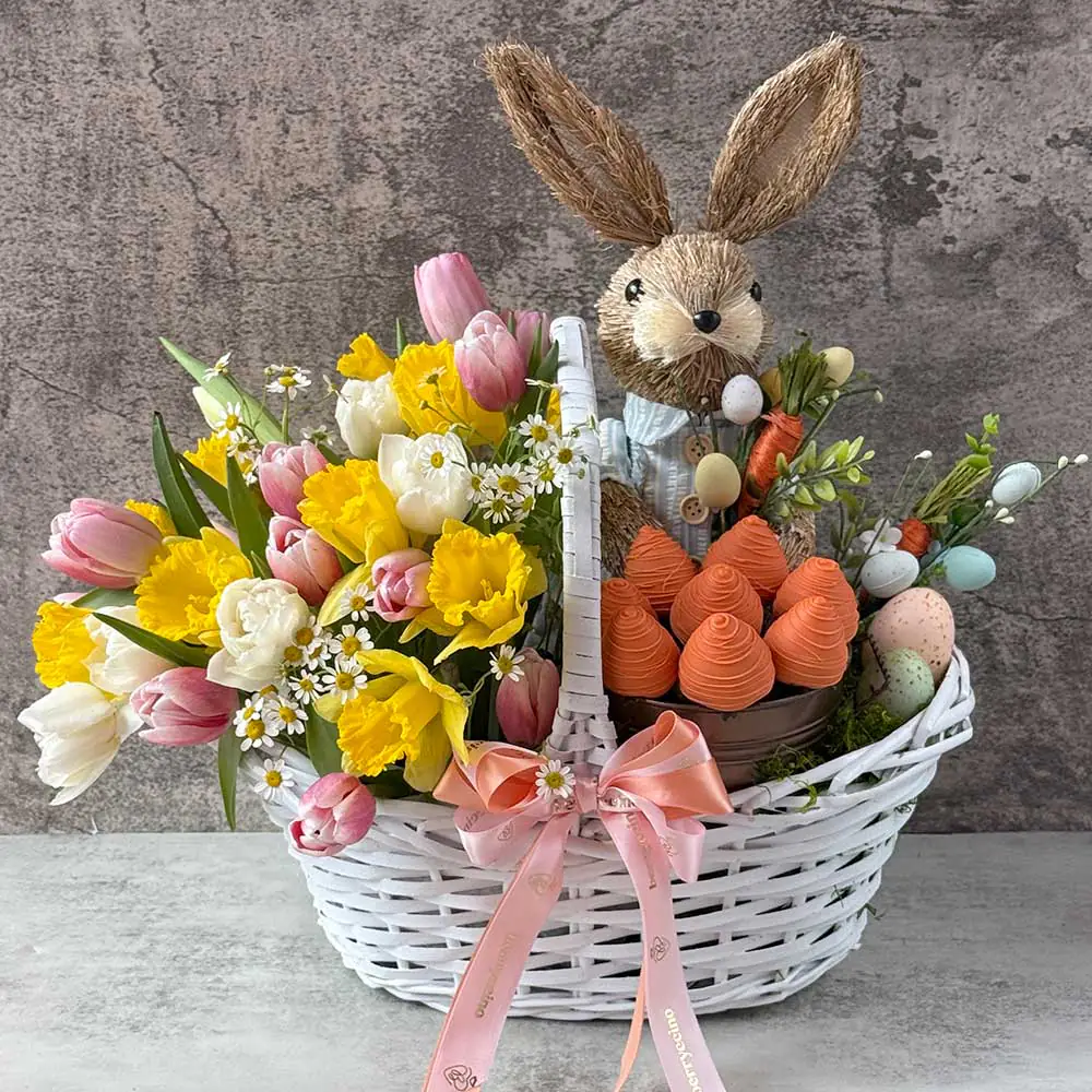 Easter flower and chocolate basket with tulips, narcissus, and bunny decoration