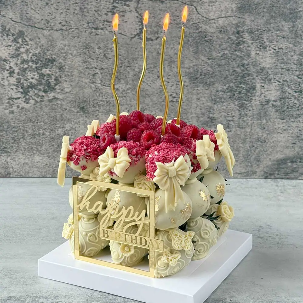 Custom Berryccino cake with Callebaut chocolate strawberries and decorative gold candle