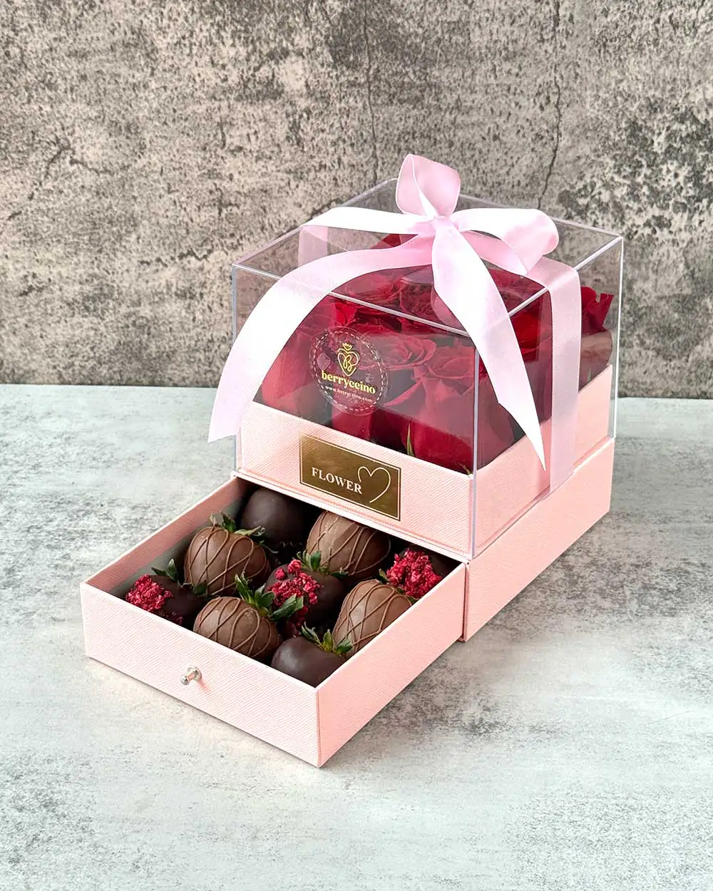 Pink box arrangement of fresh roses and dipped strawberries for mom