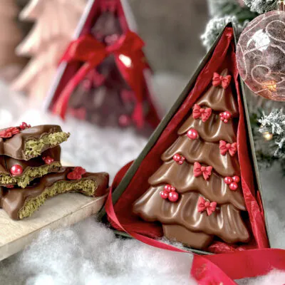 Luxury Christmas Tree Chocolate – Dubai Edition in handmade triangle gift box with festive red decorations.