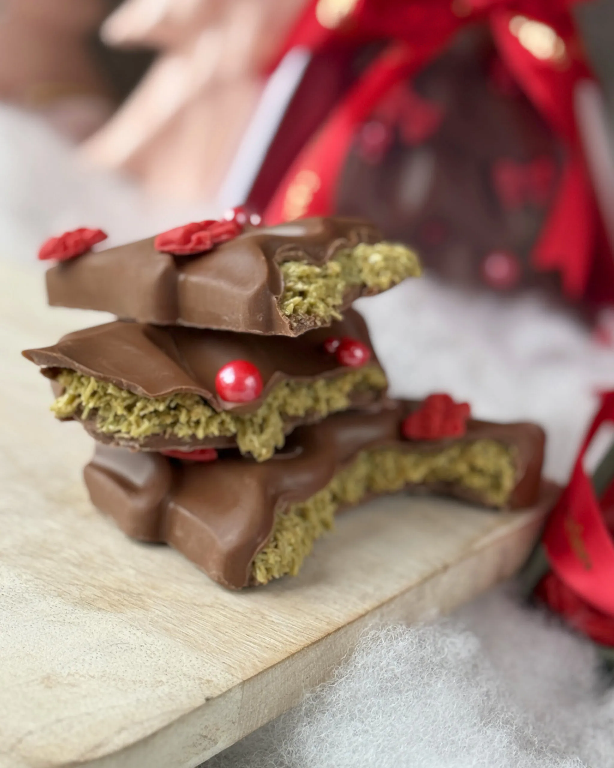 Stacked pieces of Christmas Tree Chocolate – Dubai Edition showing Dubai-style crispy filling.