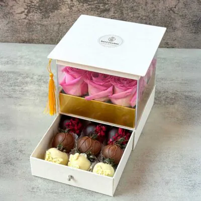 The Golden Tassel graduation gift box with fresh pink roses and chocolate covered strawberries